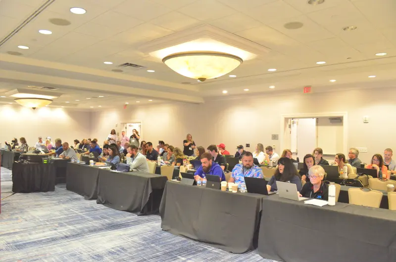 Conference attendees in session